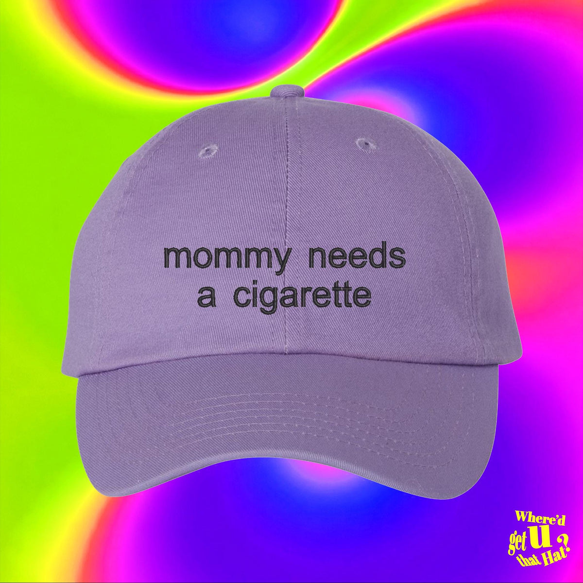 A purple baseball cap with the text "Mommy needs a cigarette" printed on it, against a colorful, rainbow-like background.